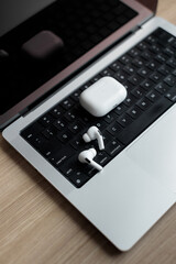 white wireless headphones on a laptop.