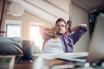Young man working from home on his laptop