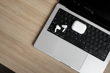 white wireless headphones on a laptop.