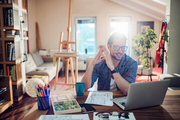 Young man working from home on his laptop