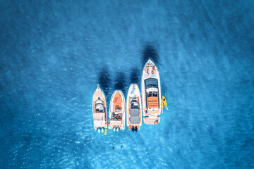 Aerial view of luxury yachts and boats on blue sea at sunrise in summer. Travel in Sardinia, Italy....