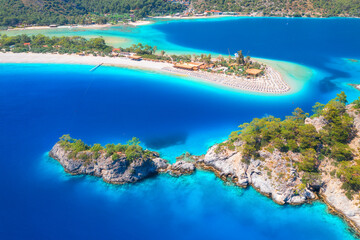 Aerial view of sea bay, rock, sandy beach, trees, mountain at sunny day in summer. Blue lagoon in...