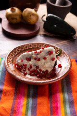 Chiles en Nogada, Typical dish from Mexico. Prepared with poblano chili stuffed with meat and fruits and covered with a walnut sauce. Named as the quintessential Mexican dish for national holidays.