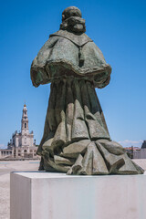 Statue of homage to Pope Paul VI with the Basilica of Our Lady of Rosary in the background at the Sanctuary of Fátima, PORTUGAL