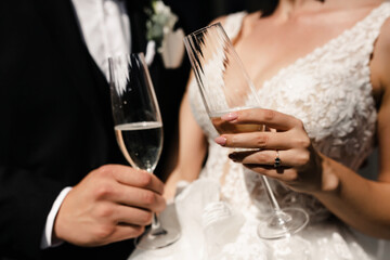 glasses of champagne at the wedding in the hands of the bride and groom © Harbuzenko