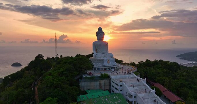  aerial view around Phuket big Buddha in beautiful sunset..360 degree view on Phuket big Buddha viewpoint..Video clips for travel and religious ideas..smooth cloud in stunning sky background.