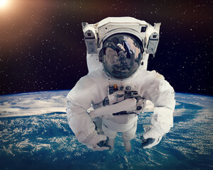 Astronaut against the earth. The elements of this image furnished by NASA.