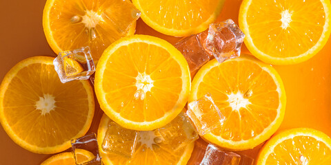 Orange slices and ice cubes with sparkling juice, fresh fruit lemonade with sparkling water and ice cubes, summer lemonade orange drink. Flat lay, top view