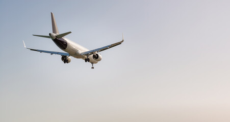 White passenger airplane flying in the sky