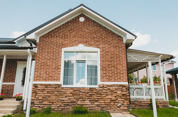Traditional English one-story red brick house.