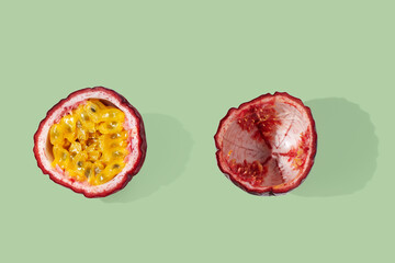 Purple Passion fruit cut in half slices on green pastel background