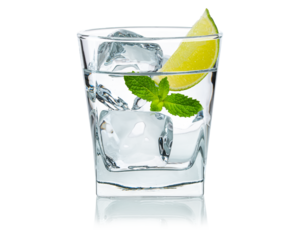 Glass of water with ice cubes, lime slice, fresh mint leaves. Cold lemonade. Frozen water in shape of cube. Ice for lime drink, lemon soda or cocktails. Natural or real ice cubes. Isolated background
