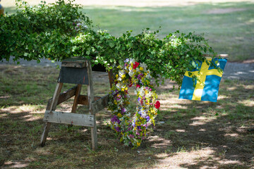 Traditional midsummer pole with Swedish flag awaits the rising ceremony.