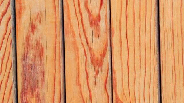 Background, wooden surface made of polished boards with texture, rotating, turning, close-up, looped video
