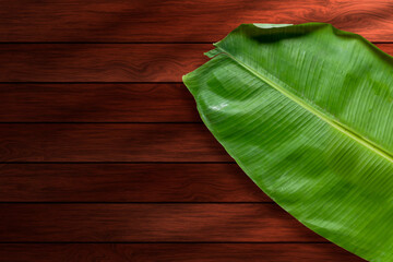 banana leaf on wooden background with copy space for text or image