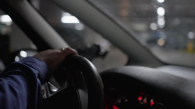 Male hands turn the steering wheel while driving along the street. 4k video