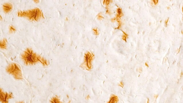 Pita tortilla close-up surface baked, rotating, turning, close-up, looped video
