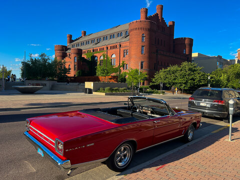 MADISON, WISCONSIN, JULY 14 2022: Ford Galaxie 500 with background of Wisconsin State University old stye building in the city with a blue sky summer background