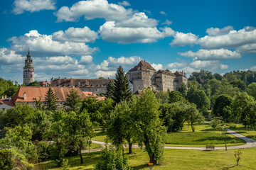 Fototapeta na wymiar View of Cesky Krumlov castle from the town park with cloudy blue sky