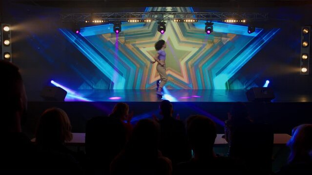 Young female woman girl dancer is performing her dance during talent show auditions. Recording of television style broadcast talent show