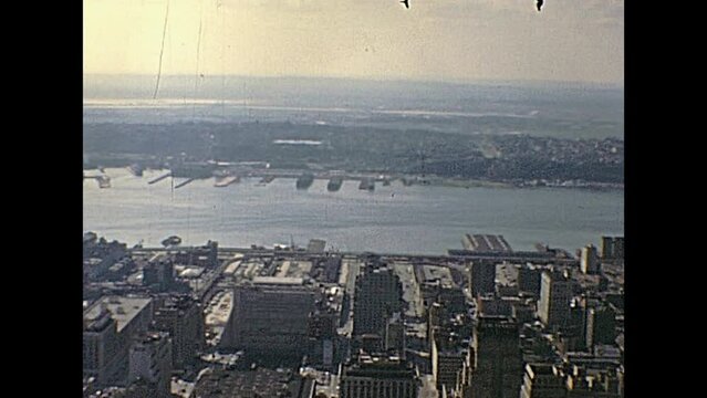New York city, United States of America - circa 1970: vintage cityscape of NYC and East river from the Top of the Empire State Building and Macys Building.