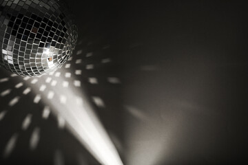 Shiny disco ball on black background, top view with color toned. Space for text