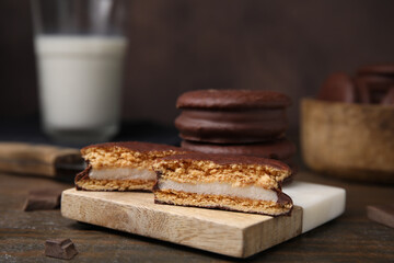 Tasty choco pies on wooden table, closeup. Space for text