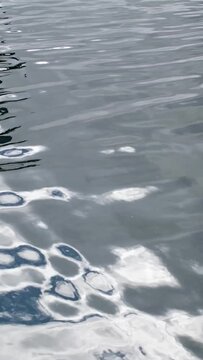 reflection in clean clear water gray color sun light rays of daylight lantern or pillar ripples on sea