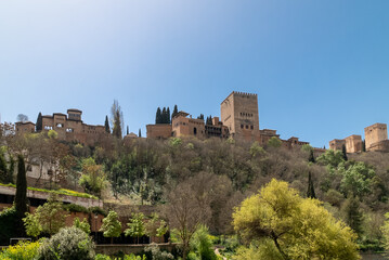 Fototapeta na wymiar Granada,Spain. April 14, 2022: Alhambra castle panoramic landscape with blue sky.