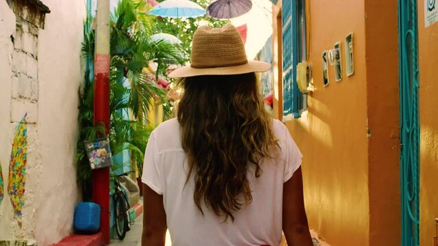 Young female tourist walking in the colorful Colombian streets.