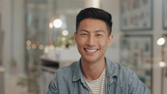 Happy, face and Asian man in office, web design or employee with success in professional career or creative job. Businessman, portrait with smile and designer in company, workplace or startup