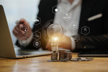 Business finance and saving power saving money by hand puting coins in jug glass 
