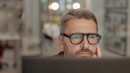 Focus, mature and businessman working in the office late with computer for web design project. Technology, deadline and male designer with overtime doing research on a desktop in workplace at night.