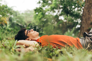 Man relaxing lying on the grass. connecting to nature concept.
