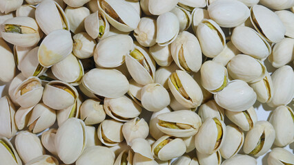 Slow motion footage of a group of raw pistachios cracking open. Enjoy the tasty and protein rich kernels as a vegan snack.