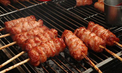 Grilled pork sausage on charcoal. Nem nuong Ninh Hoa on street of Hi Chi Minh city, Viet Nam. One of many yummy local foods in town.