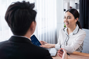 Conversational job interview between interviewer and candidate. Asian female job applicant present...