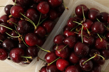 Fresh cherries in a tray on a wooden background. fresh ripe cherries. sweet cherries