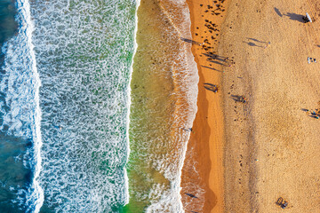 Fototapeta na wymiar Waves crashing on the sandy beach