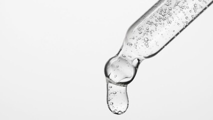 Closeup cosmetic serum fluid gel with bubbles from dropper, pipette over white - Powered by Adobe