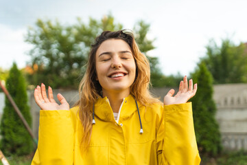 The girl enjoys the summer rain. A warm summer rain falls. The girl laughs and rejoices. Summer rain.