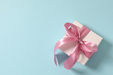 beautiful gift in kraft paper with a pink ribbon, space for text