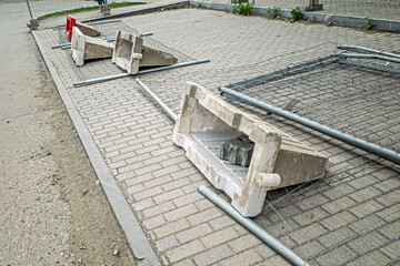 Plastic barriers lie on the edge of the road on a summer day