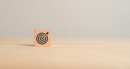Business goals concept. Focus on goals achievement. Wooden cube block with goals, target icon on...