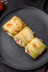 Delicious healthy vegetarian vegetable roll of zucchini, tomatoes, peppers and sauce