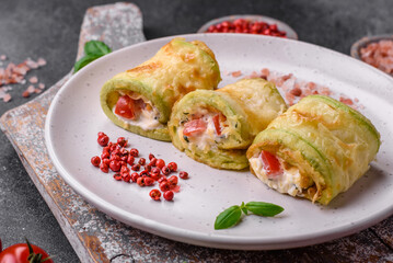 Delicious healthy vegetarian vegetable roll of zucchini, tomatoes, peppers and sauce
