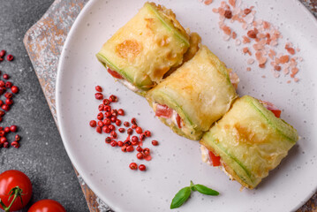 Delicious healthy vegetarian vegetable roll of zucchini, tomatoes, peppers and sauce