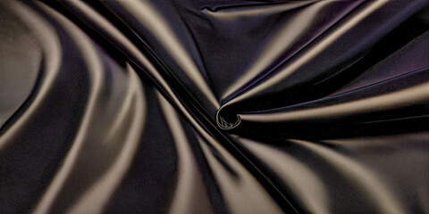 Fototapeta premium Texture, background, pattern. Black silk fabric.Pure Silk Charmeuse Crepe Backed Satin in BLACK fabric. Wide Stretch Silk Charmeuse Black By the Yard
