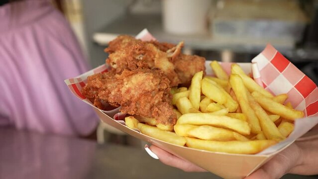 Chicken and fries meal ready to be served to a customer