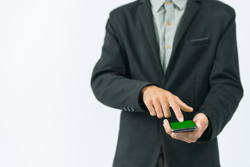 Businessman in half black suit standing Right hand holding a phone with a green screen. Left hand about to touch screen on white background - Powered by Adobe